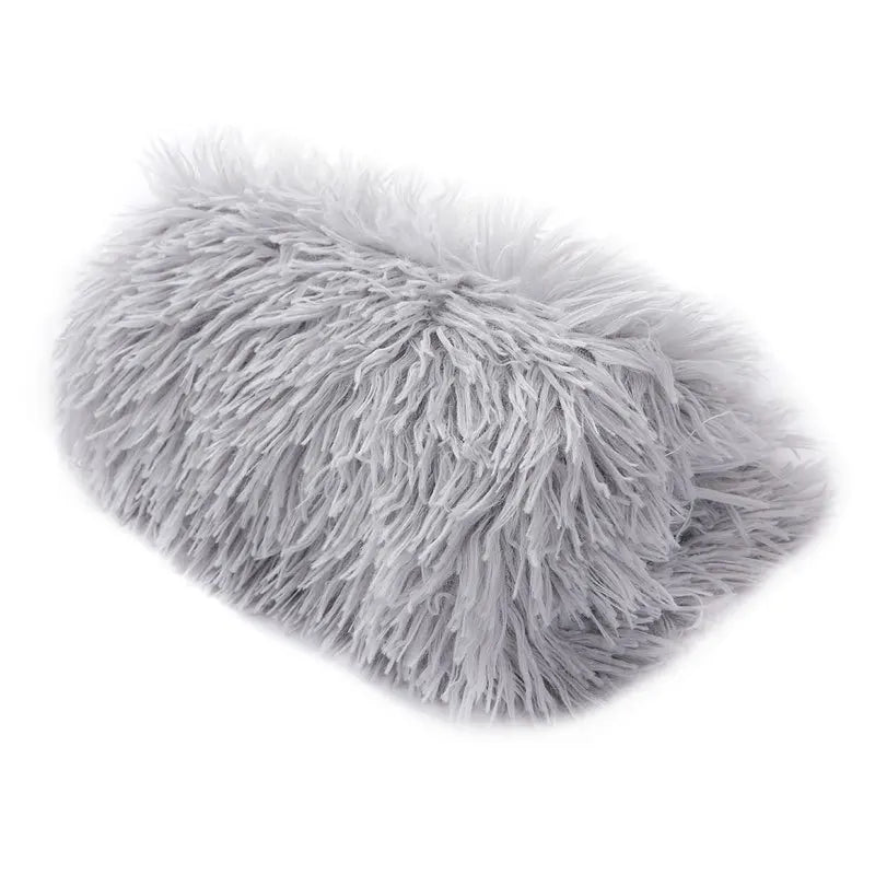 Petit chien roulé en boule sur la couverture polaire